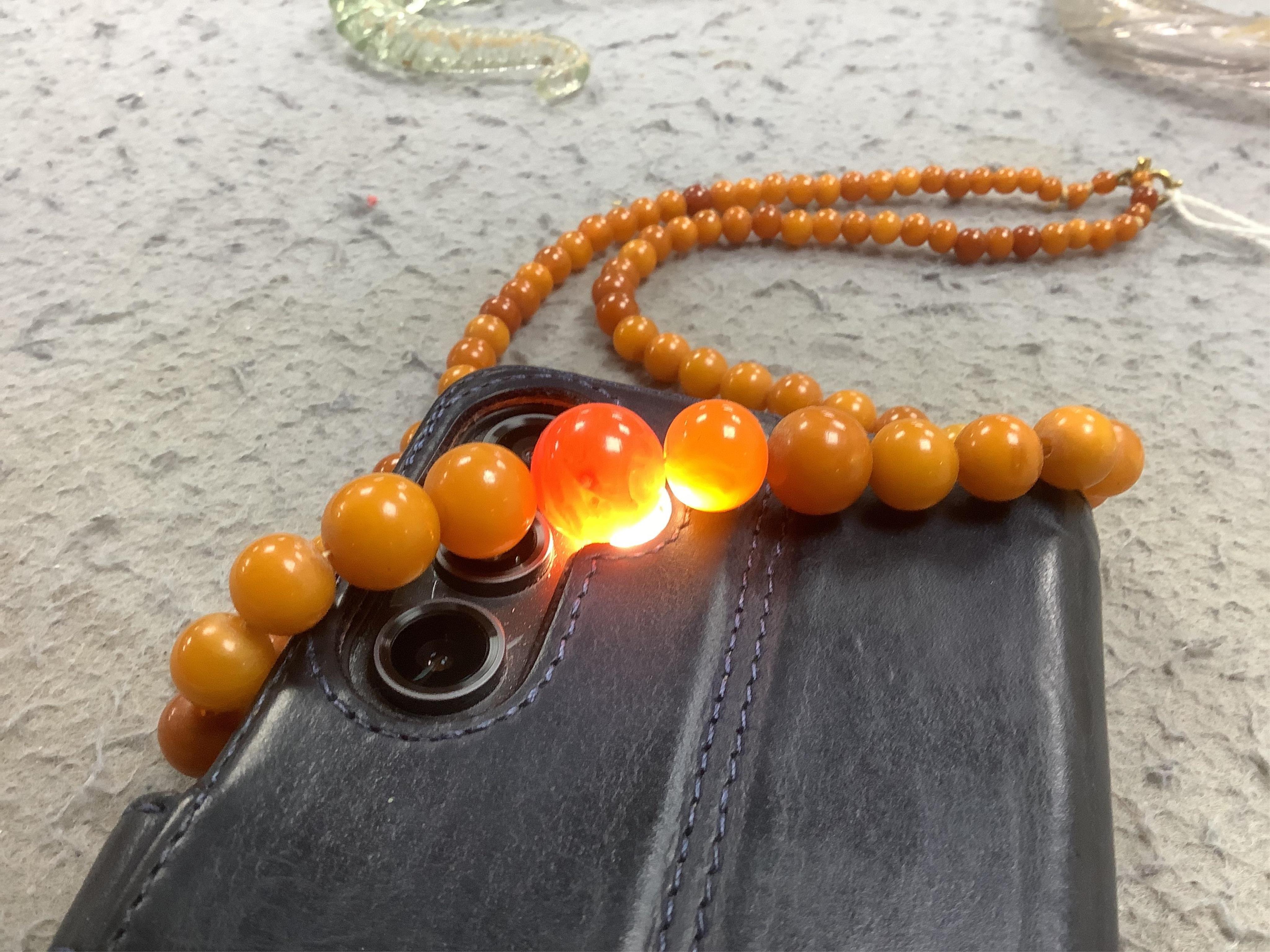 An amber bead necklace, composed of graduated amber beads measuring approximately 15.7-3.6mm, length 58cm, gross weight 23 grams. Condition: overall good, some minor crazing, some minor wear, commensurate with age